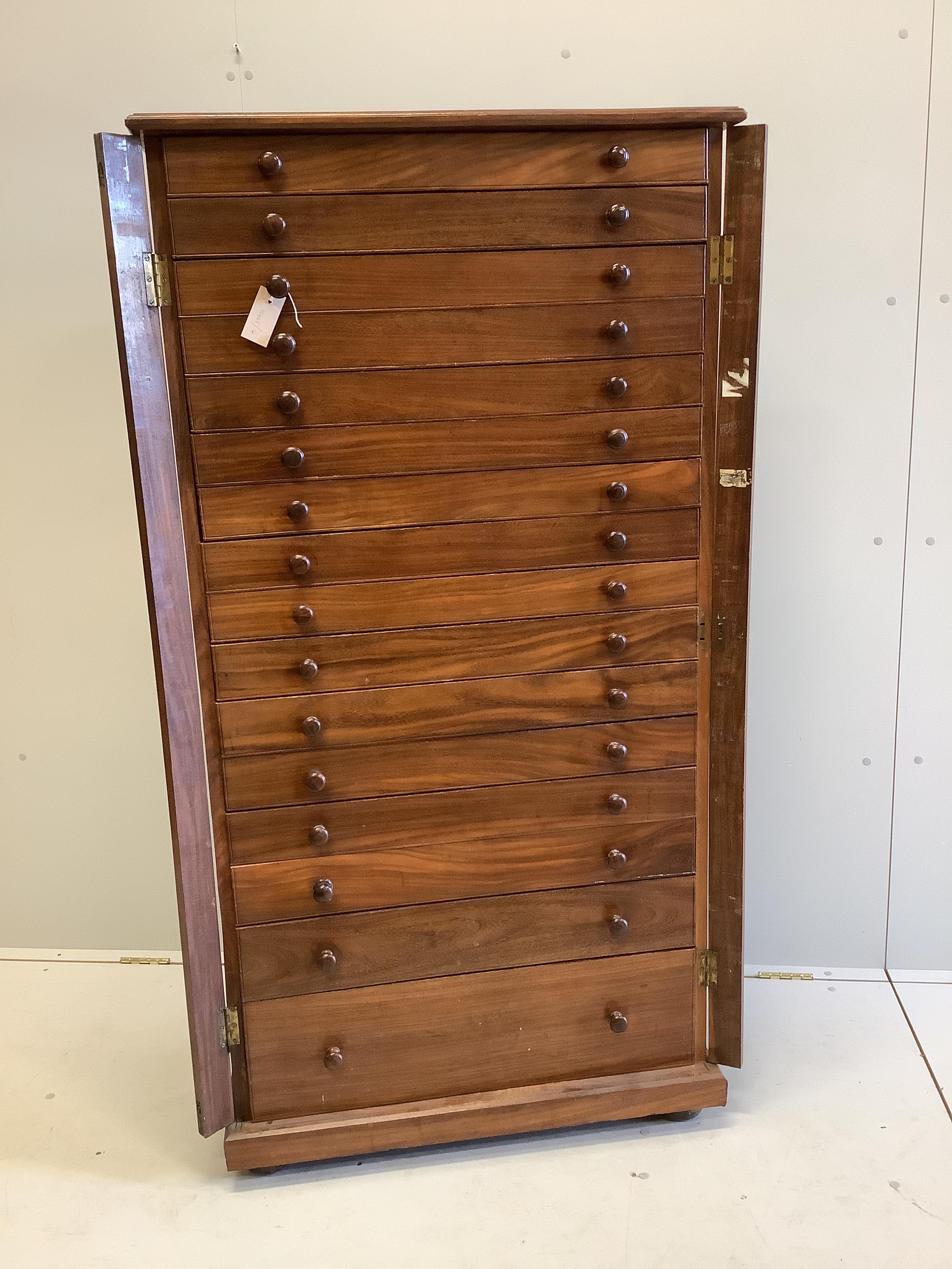 A mid century Sri Lankan mahogany collector's cabinet fitted sixteen graduated drawers, back panel stamped Don Andris, Cabinet Makers, Colombo, width 80cm, depth 44cm, height 156cm